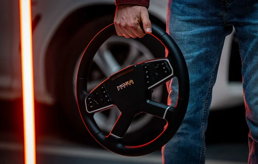 Hand held Moza Racing steering wheel