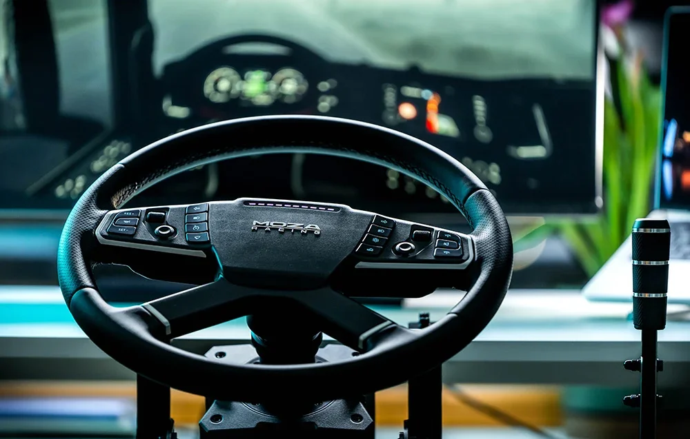 Gaming steering wheel moza racing with backlight, monitor in the background