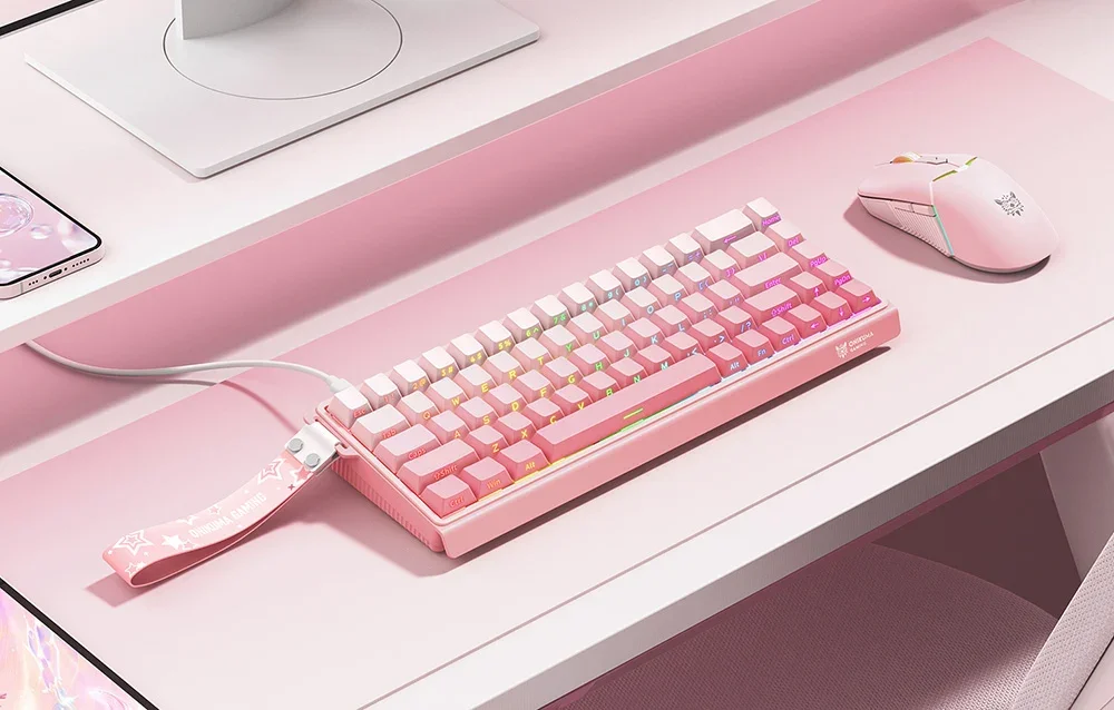 Onikuma pink keyboard on the desk next to the mouse