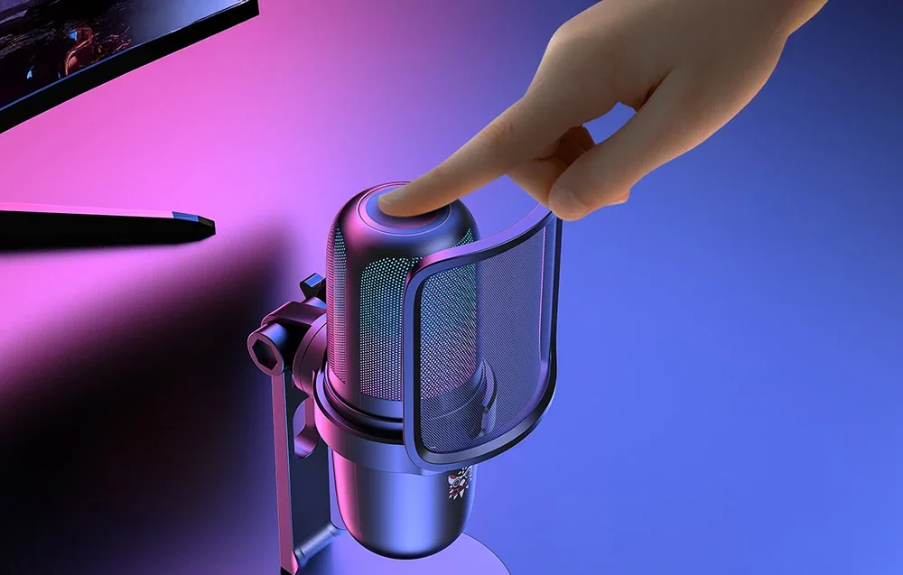 Finger on Onikuma microphone, monitor in the background